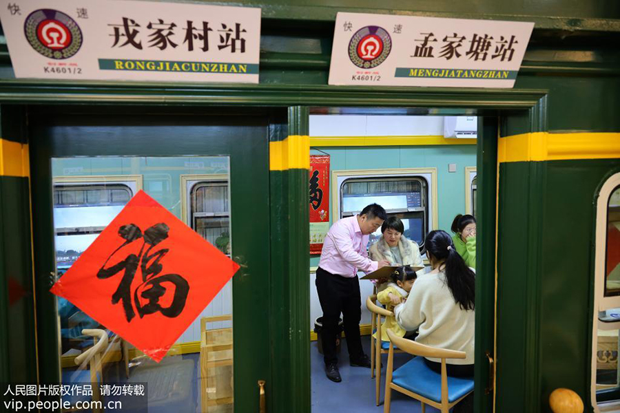 12月10日，郭峰在他的火车餐厅为顾客推荐菜品。